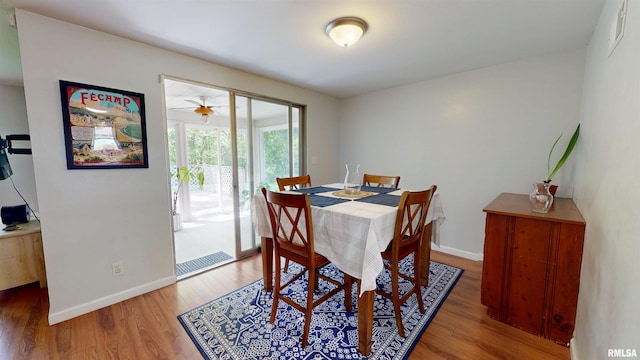 dining area with wood finished floors and baseboards