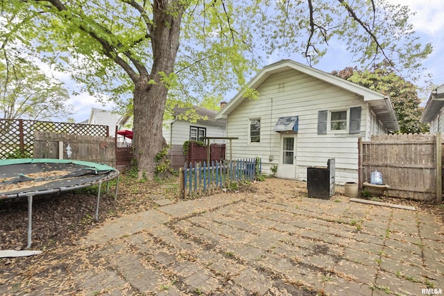 910 W Virginia Ave, Peoria, IL 61604 - rear view of property with a trampoline and a fenced backyard