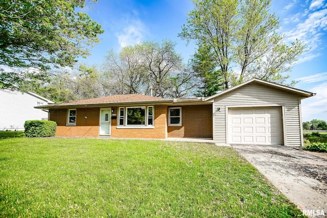 ranch-style house with an attached garage, concrete driveway, a front lawn, and brick siding