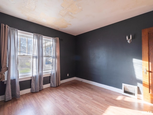 empty room featuring wood finished floors and baseboards