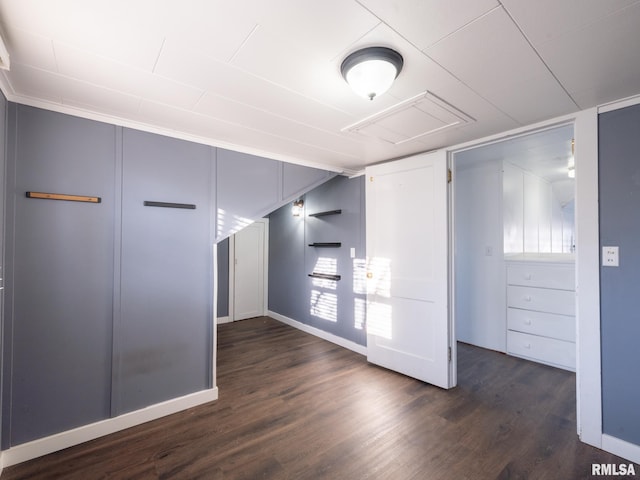 unfurnished bedroom with dark wood finished floors and baseboards