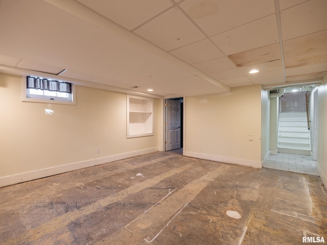 basement with stairs and baseboards