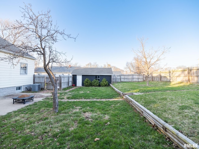 view of yard featuring an outbuilding, central AC, and a patio