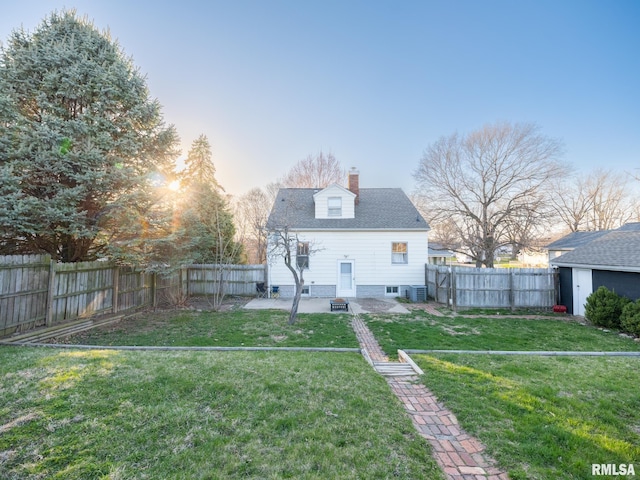 rear view of house with a chimney, central air condition unit, a patio, and an outbuilding