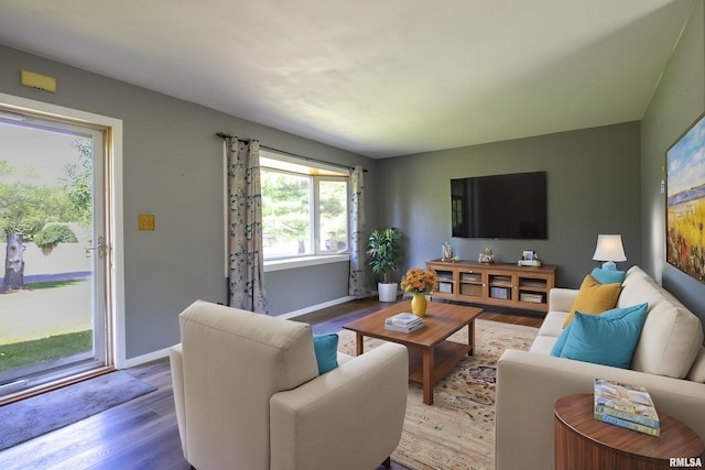 living room featuring wood finished floors and baseboards