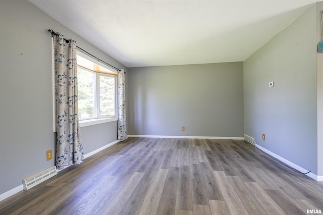 empty room with wood finished floors and baseboards