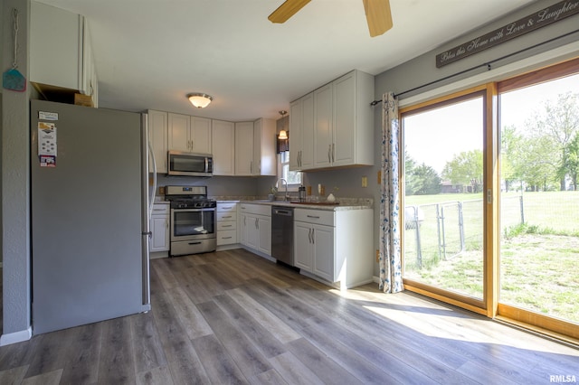 kitchen with stainless steel appliances, plenty of natural light, and wood finished floors