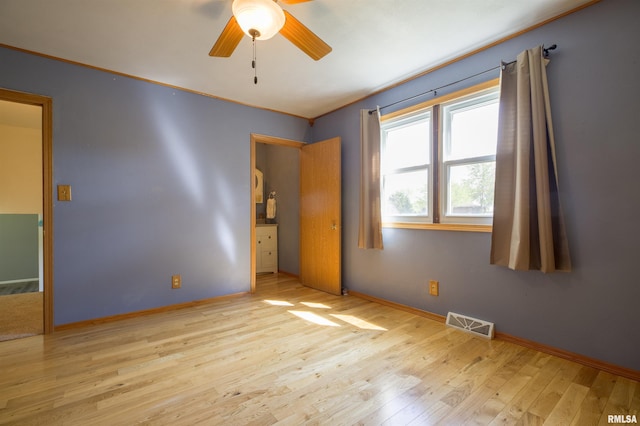 unfurnished room featuring wood finished floors, a ceiling fan, crown molding, and baseboards