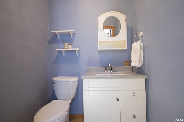 bathroom with toilet and vanity