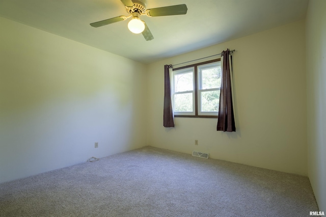 spare room with carpet floors and a ceiling fan