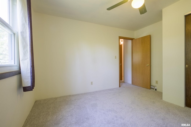 spare room featuring carpet and a ceiling fan