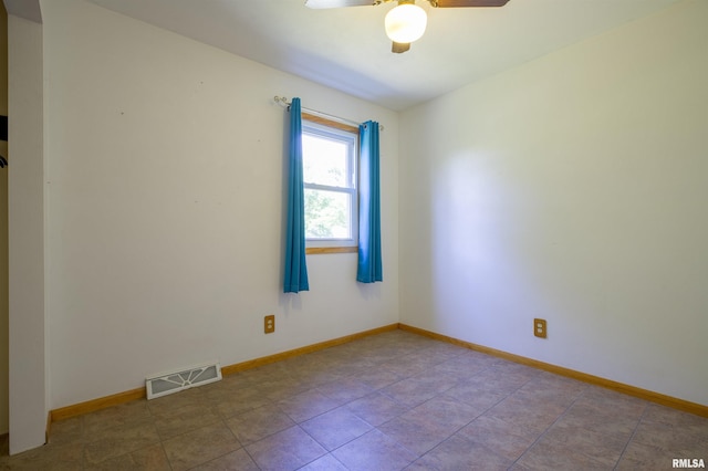 unfurnished room featuring ceiling fan, baseboards, and tile patterned floors
