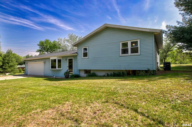 view of front facade with a garage, a front lawn, concrete driveway, and central air condition unit