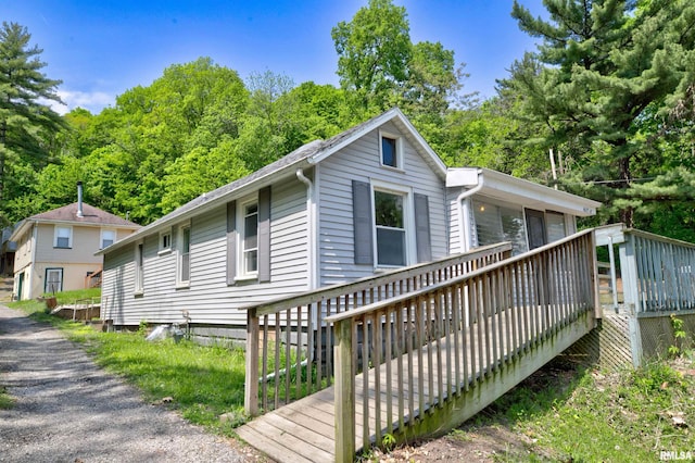 view of side of property with a wooden deck
