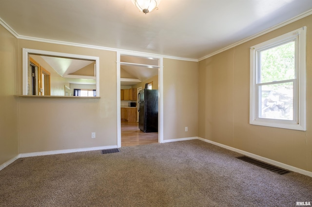 carpeted spare room with baseboards and ornamental molding