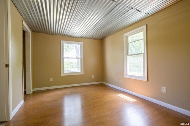 spare room featuring wood finished floors and baseboards
