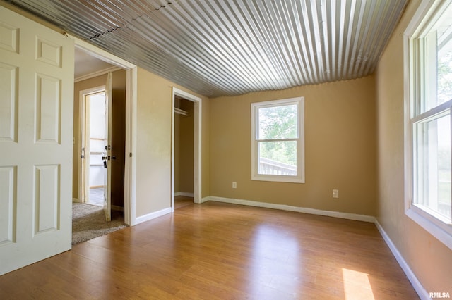 spare room featuring wood finished floors and baseboards