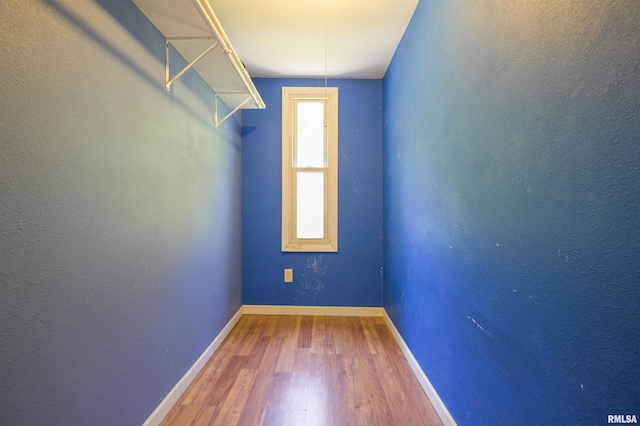 spare room with wood finished floors and baseboards