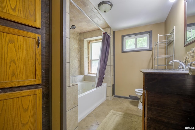 bathroom featuring tile patterned floors, toilet, vanity, baseboards, and shower / tub combo with curtain
