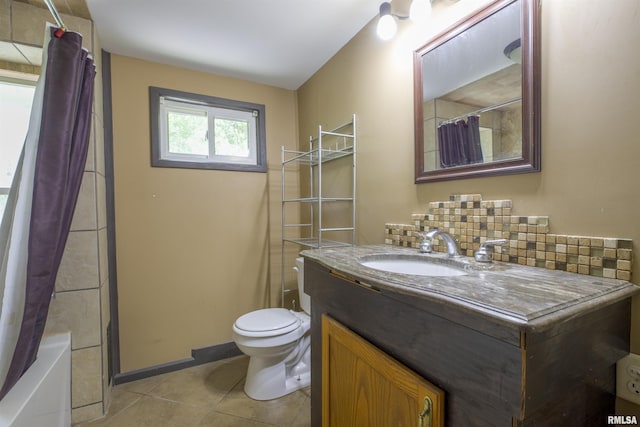 full bath with tile patterned flooring, toilet, vanity, decorative backsplash, and baseboards