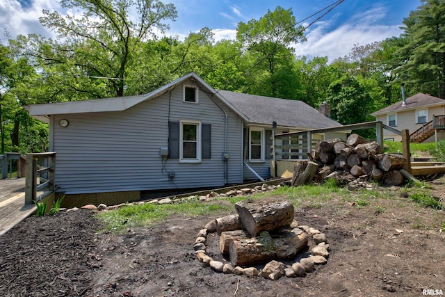 rear view of house featuring a deck