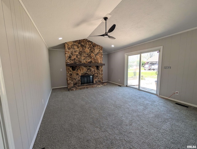 unfurnished living room with a ceiling fan, baseboards, lofted ceiling, ornamental molding, and carpet flooring