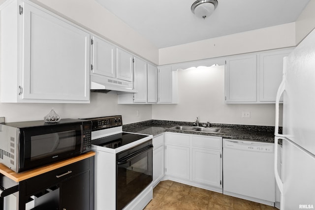 kitchen with white appliances, under cabinet range hood, a sink, dark countertops, and white cabinetry