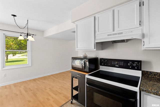 kitchen featuring black appliances, under cabinet range hood, white cabinetry, light wood-style flooring, and hanging light fixtures