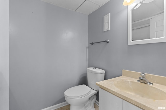 bathroom with baseboards, toilet, and vanity