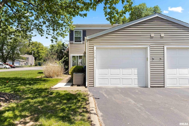 view of front of property with central AC unit and a front lawn