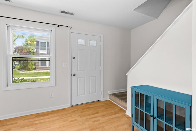 entrance foyer with light wood-type flooring and baseboards