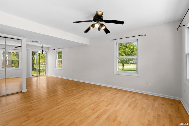 unfurnished room featuring healthy amount of natural light, light wood-style flooring, baseboards, and a ceiling fan