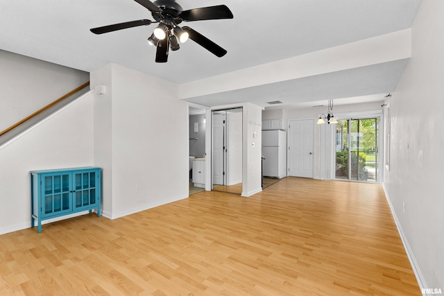 unfurnished living room featuring light wood-type flooring, baseboards, and ceiling fan