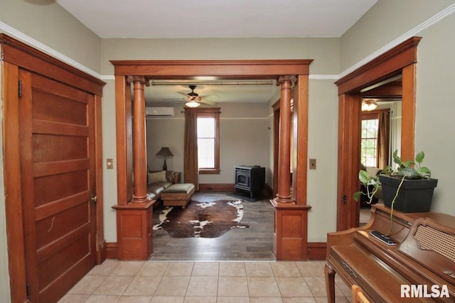 102 2nd St, Camp Grove, IL 61424 - sitting room featuring ornate columns, a wood stove, light tile patterned flooring, and a wall mounted AC