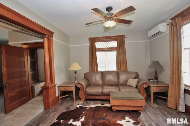 102 2nd St, Camp Grove, IL 61424 - living room with a wall unit AC, ceiling fan, plenty of natural light, and wood finished floors