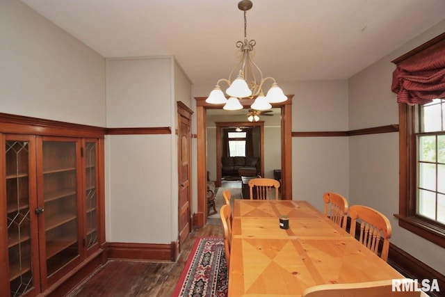 102 2nd St, Camp Grove, IL 61424 - dining space featuring dark wood-style flooring, a chandelier, and baseboards