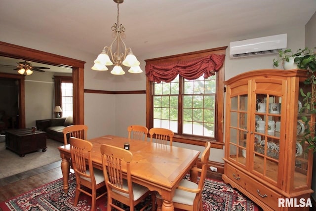 102 2nd St, Camp Grove, IL 61424 - dining area featuring a wall mounted AC, a chandelier, dark wood finished floors, and ceiling fan