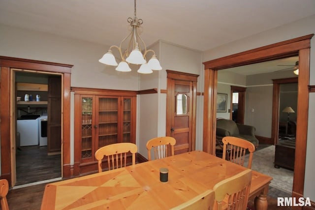102 2nd St, Camp Grove, IL 61424 - dining space featuring a chandelier, washing machine and clothes dryer, a ceiling fan, and dark wood-type flooring