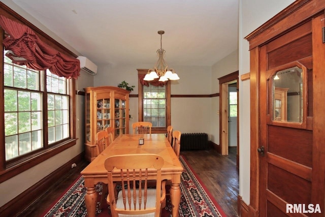 102 2nd St, Camp Grove, IL 61424 - dining room with dark wood-style floors, a chandelier, a wall mounted air conditioner, radiator, and baseboards