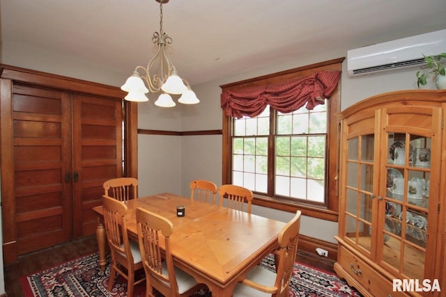 102 2nd St, Camp Grove, IL 61424 - dining area with an AC wall unit, dark wood finished floors, and a chandelier