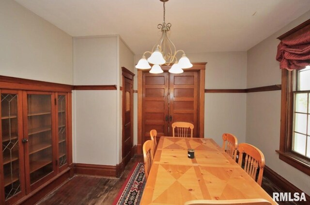 102 2nd St, Camp Grove, IL 61424 - dining room featuring dark wood-style floors, baseboards, a chandelier, and plenty of natural light