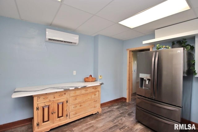 102 2nd St, Camp Grove, IL 61424 - kitchen featuring stainless steel refrigerator with ice dispenser, a wall mounted air conditioner, light countertops, dark wood-style floors, and a paneled ceiling