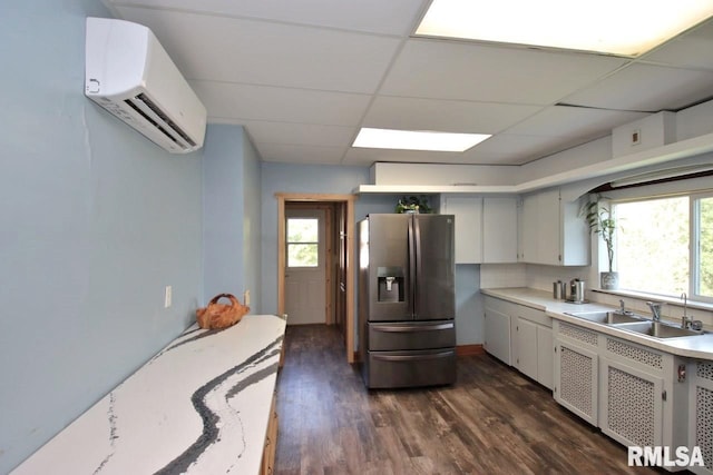 102 2nd St, Camp Grove, IL 61424 - kitchen featuring stainless steel fridge with ice dispenser, an AC wall unit, a sink, light countertops, and dark wood-style floors