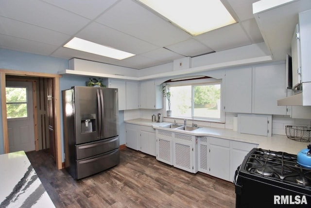 102 2nd St, Camp Grove, IL 61424 - kitchen with stainless steel fridge with ice dispenser, black gas range, a sink, light countertops, and dark wood-style floors