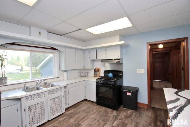 102 2nd St, Camp Grove, IL 61424 - kitchen featuring black gas range, a drop ceiling, a sink, light countertops, and dark wood-style flooring