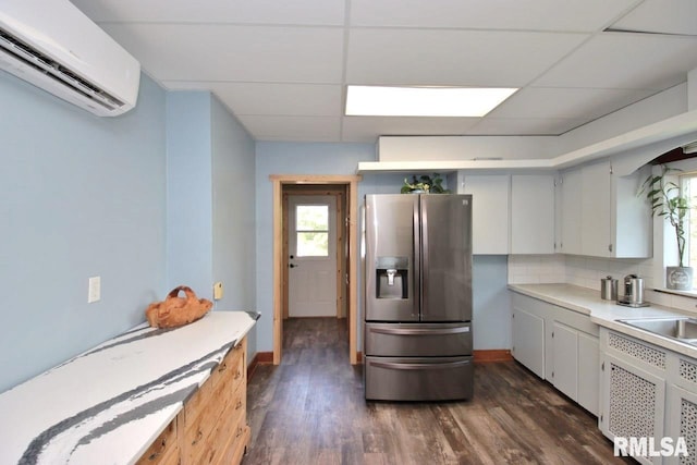 102 2nd St, Camp Grove, IL 61424 - kitchen featuring stainless steel fridge, a wall mounted AC, dark wood finished floors, light countertops, and baseboards