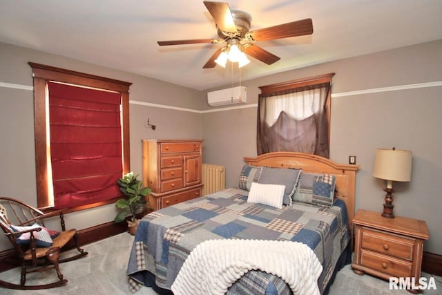102 2nd St, Camp Grove, IL 61424 - carpeted bedroom featuring radiator heating unit, a wall unit AC, baseboards, and ceiling fan