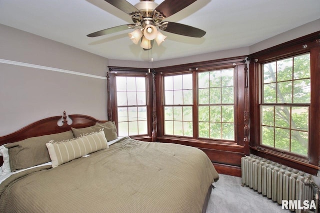 102 2nd St, Camp Grove, IL 61424 - bedroom featuring radiator heating unit, ceiling fan, and light carpet