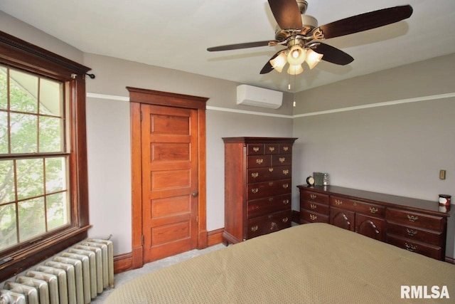 102 2nd St, Camp Grove, IL 61424 - carpeted bedroom with radiator heating unit, a wall unit AC, baseboards, and ceiling fan