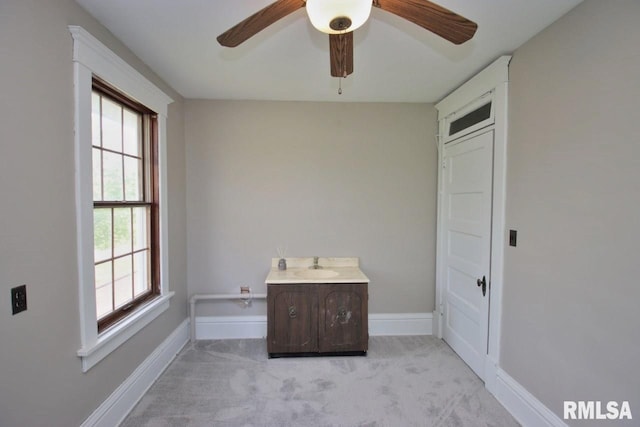 102 2nd St, Camp Grove, IL 61424 - empty room featuring a ceiling fan, baseboards, light carpet, and a sink